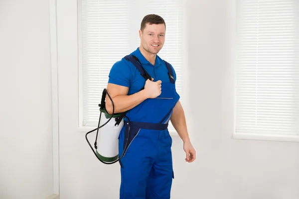 depositphotos_96534222-stock-photo-confident-male-worker-carrying-pesticide